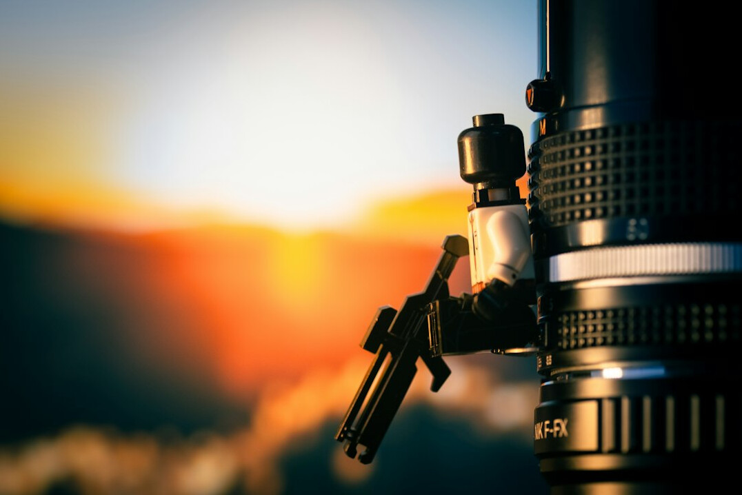 Video camera on tripod outdoors at golden hour