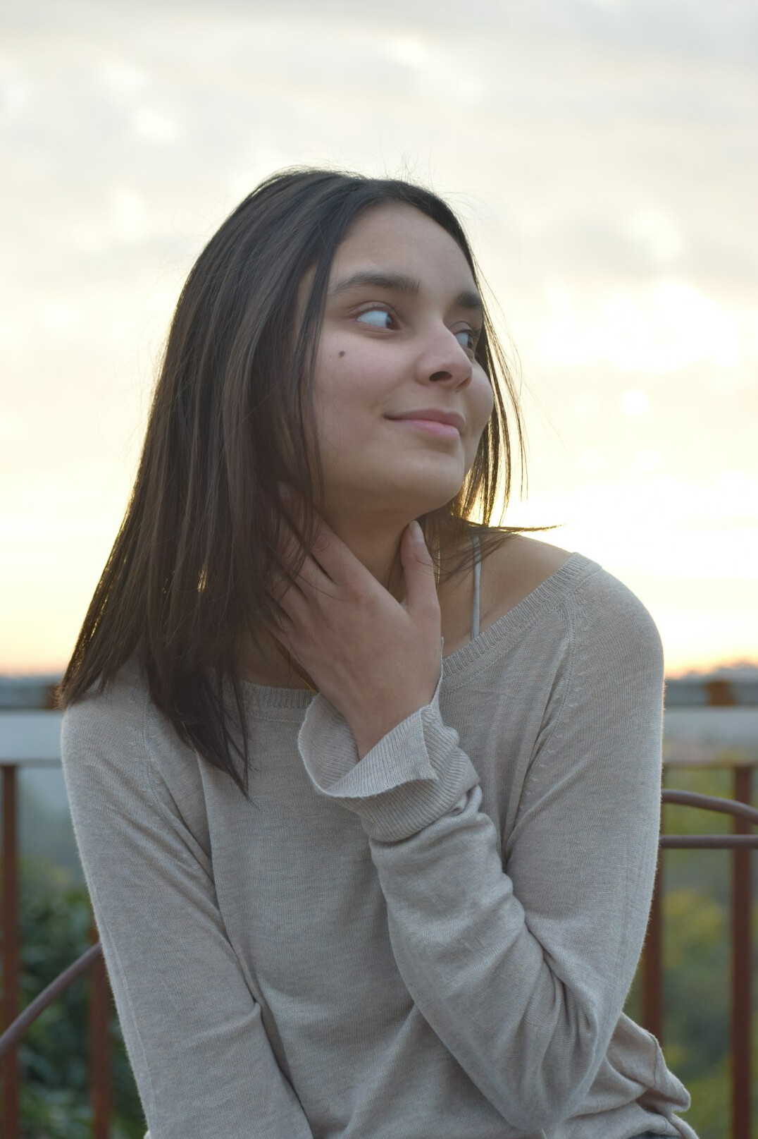 Portrait of a young woman with dark hair smiling