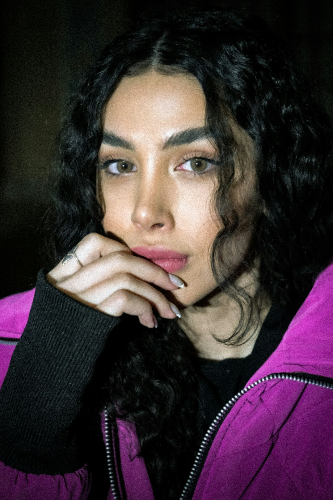 Portrait of a woman with curly dark hair