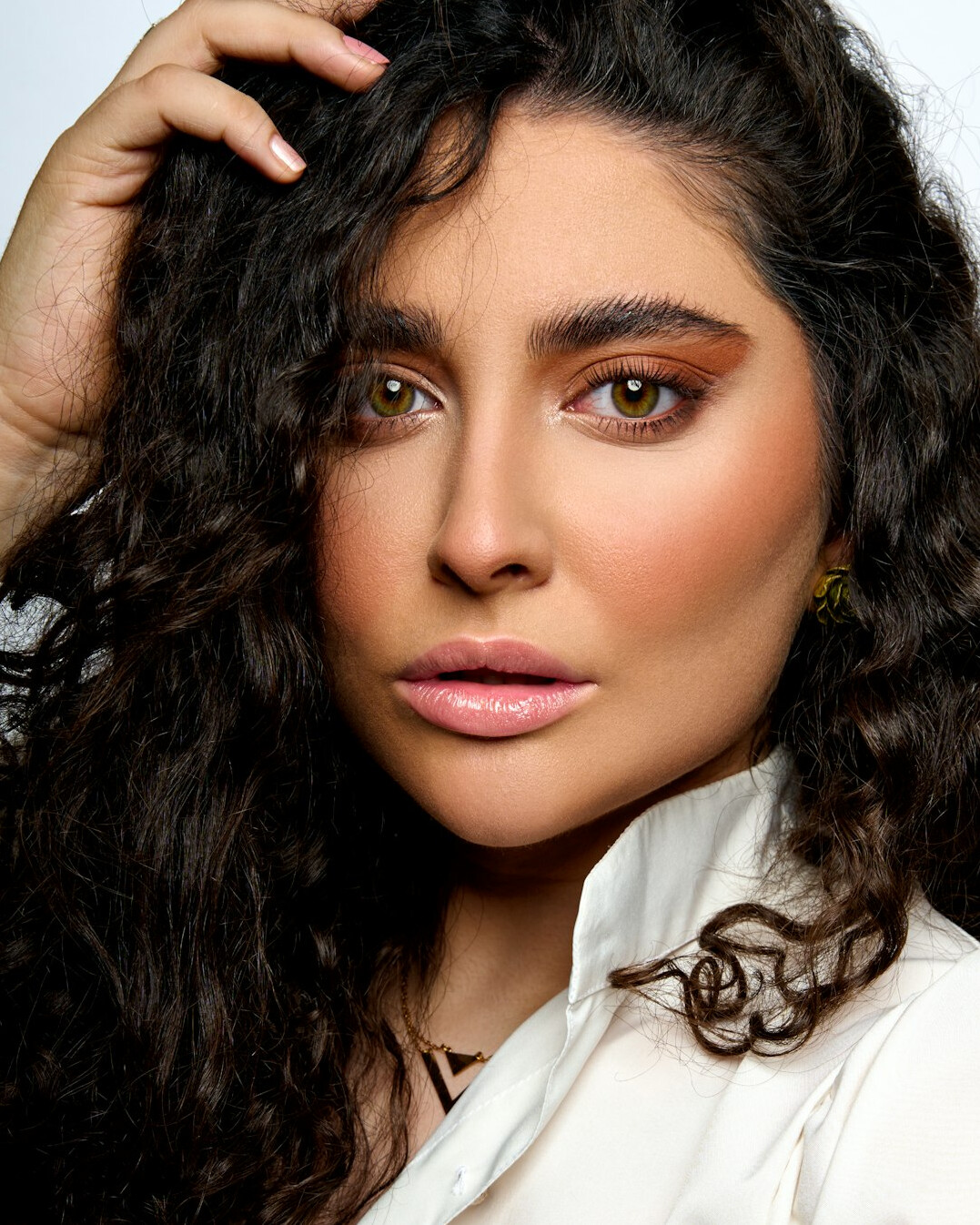 Portrait of a woman with wavy hair and natural makeup